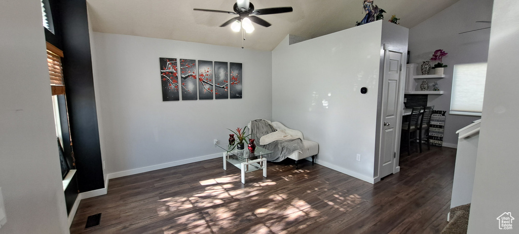Sitting room with a ceiling fan, wood finished floors, and vaulted ceiling