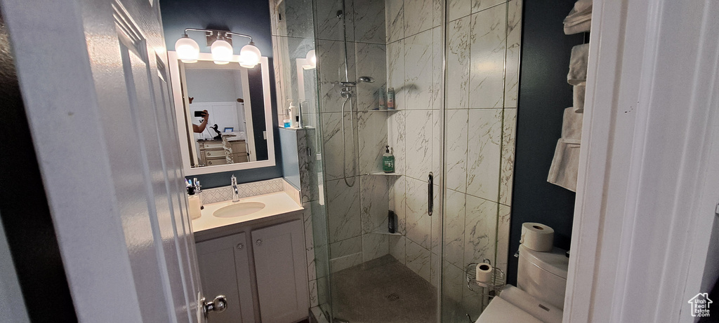Full bath with a marble finish shower and vanity