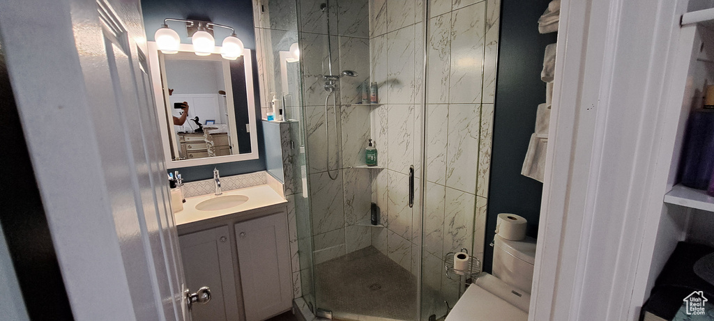 Bathroom featuring a stall shower and vanity