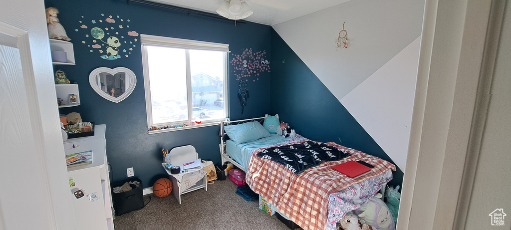 Bedroom featuring carpet flooring and lofted ceiling