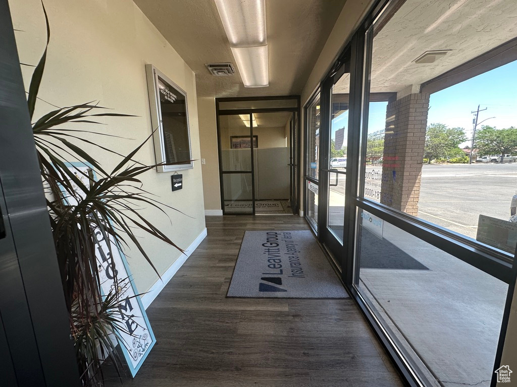 Hallway featuring wood finished floors and baseboards