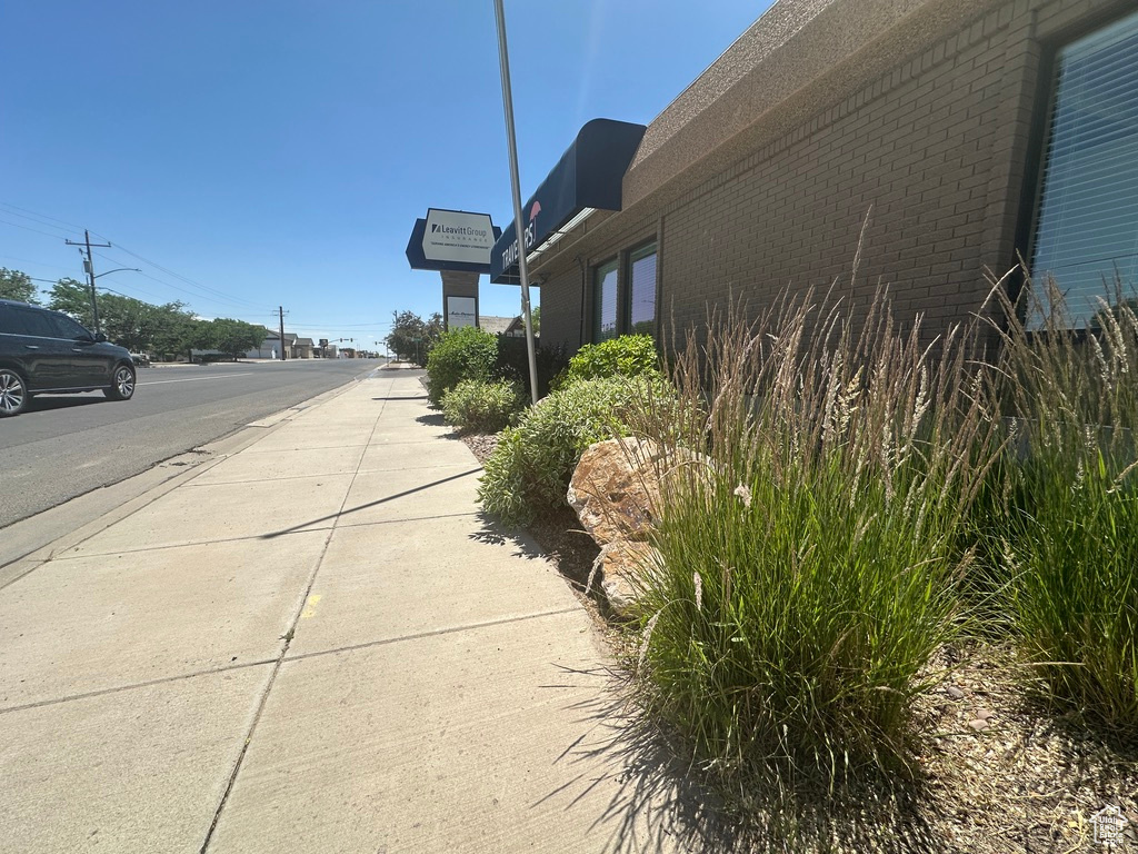 View of asphalt street with sidewalks and street lights