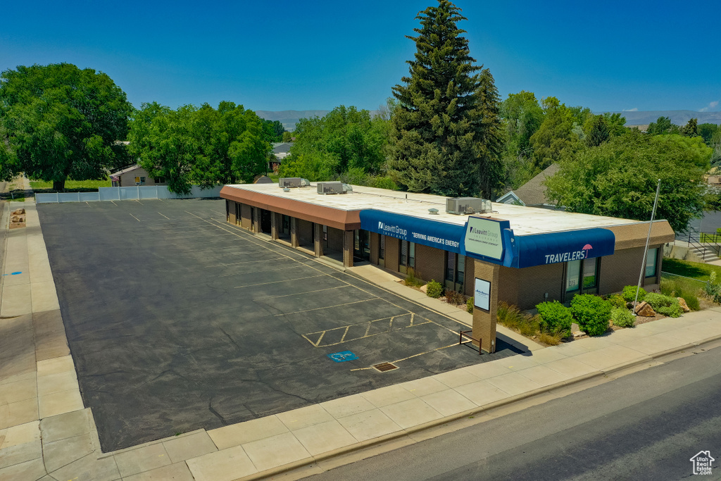 View of building exterior with uncovered parking