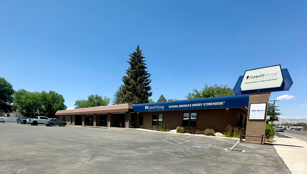 View of building exterior featuring uncovered parking
