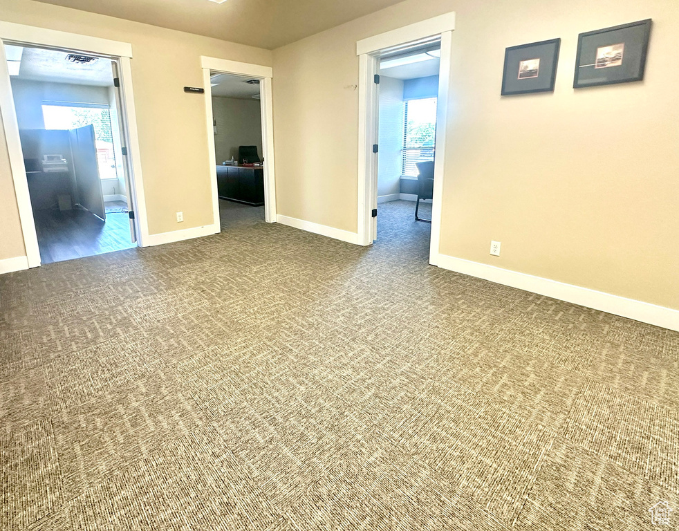 Carpeted empty room with baseboards