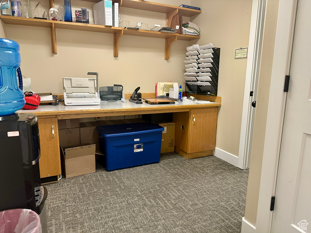 Carpeted home office featuring baseboards