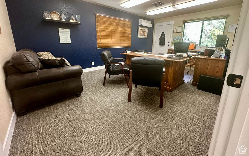Office space featuring carpet floors and a wall mounted AC