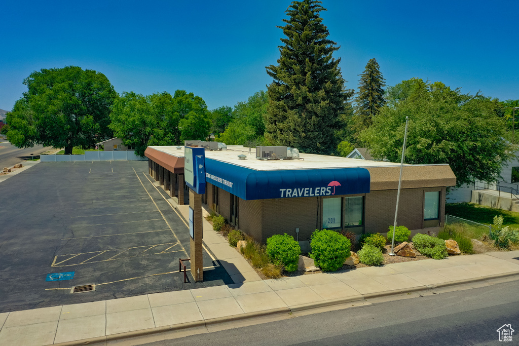 View of building exterior featuring uncovered parking