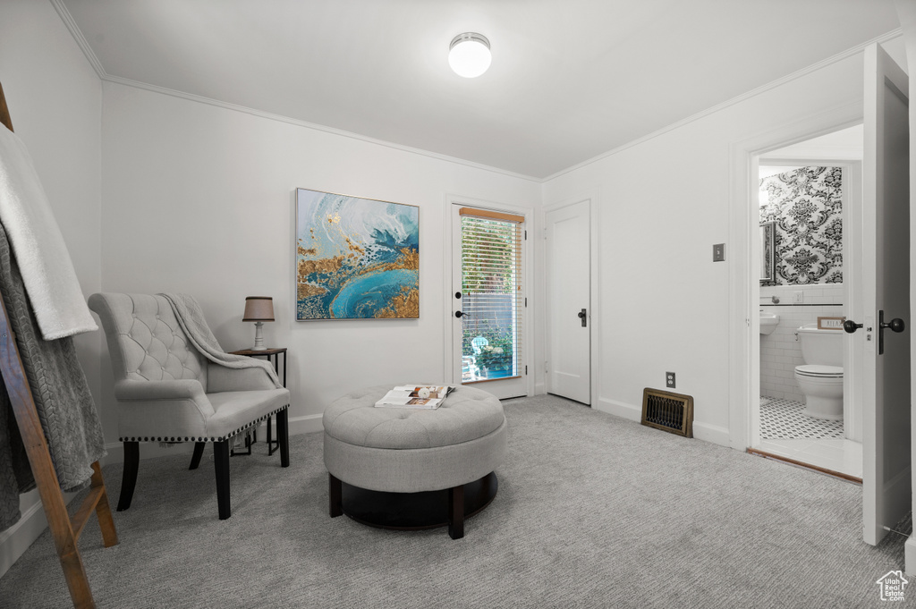 Sitting room with carpet flooring and crown molding