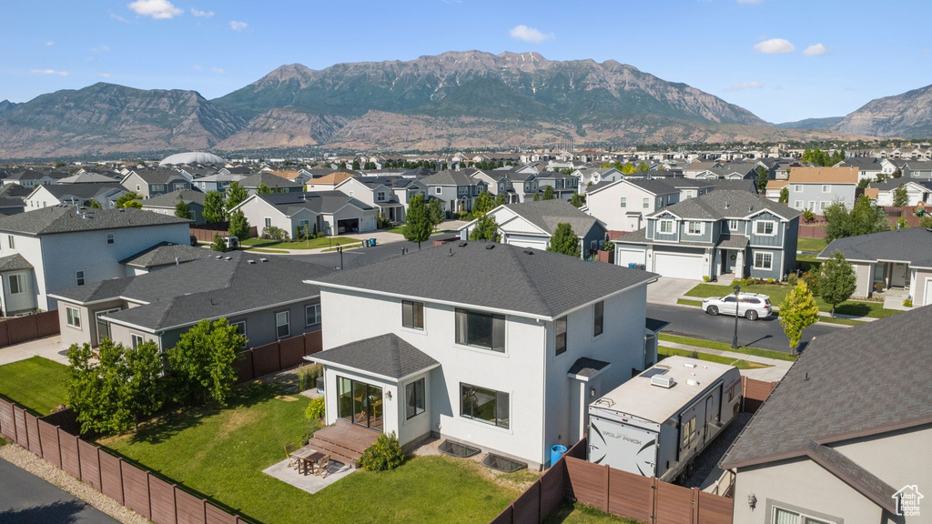 Aerial perspective of suburban area featuring a mountainous background