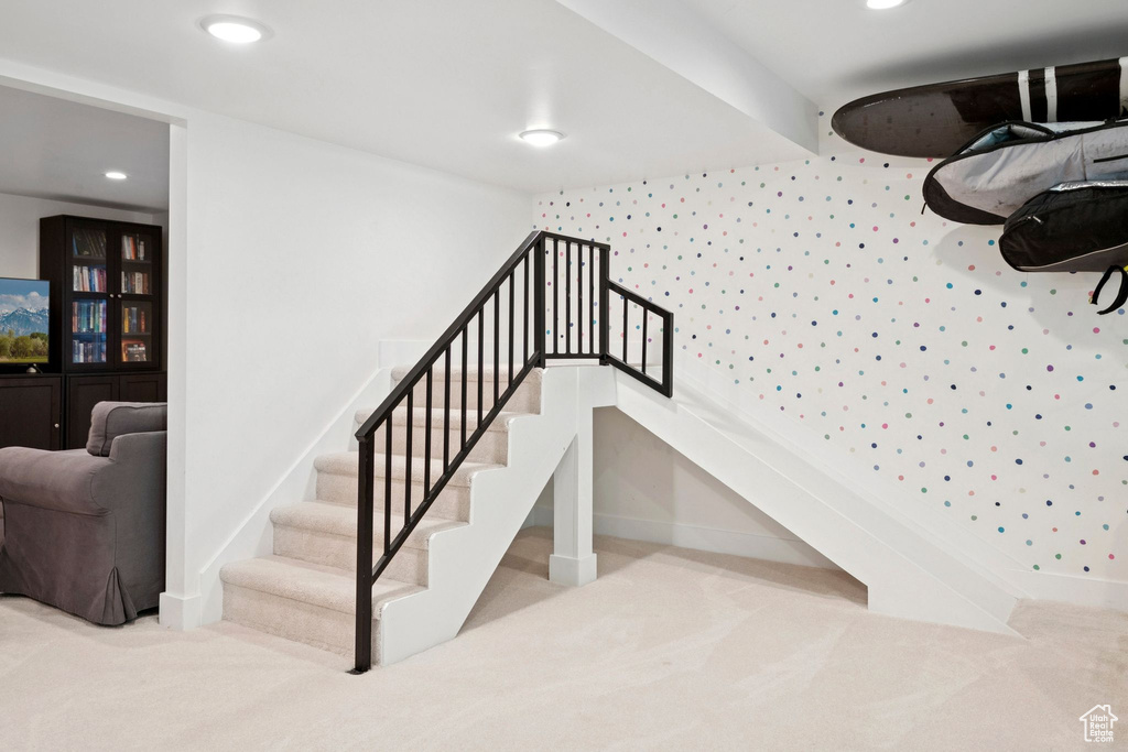 Stairway with carpet and recessed lighting