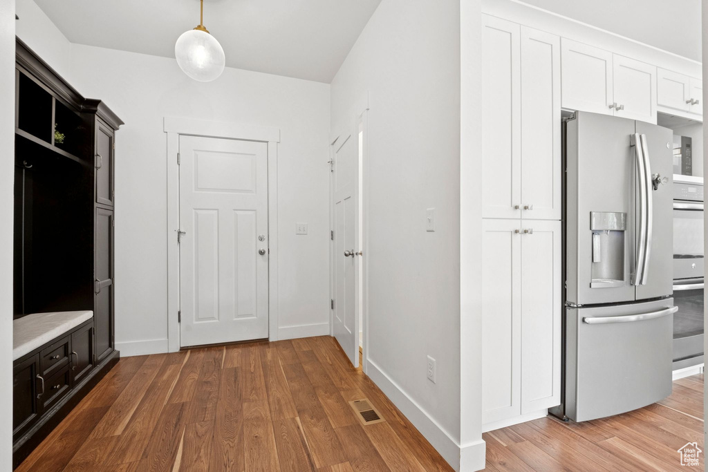 Mudroom featuring wood finished floors and baseboards