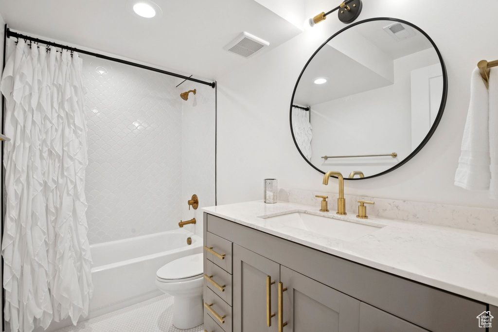 Bathroom featuring vanity, shower / bathtub combination with curtain, tile patterned floors, and recessed lighting