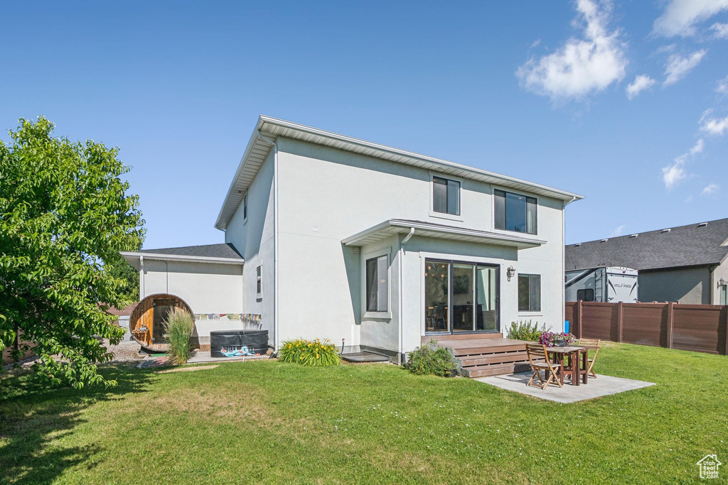 Rear view of house with a patio and stucco siding