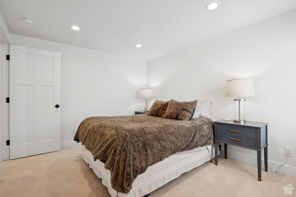 Bedroom with light carpet and recessed lighting