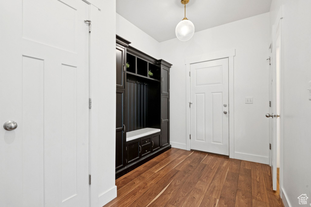 Mudroom with dark wood-style floors and baseboards