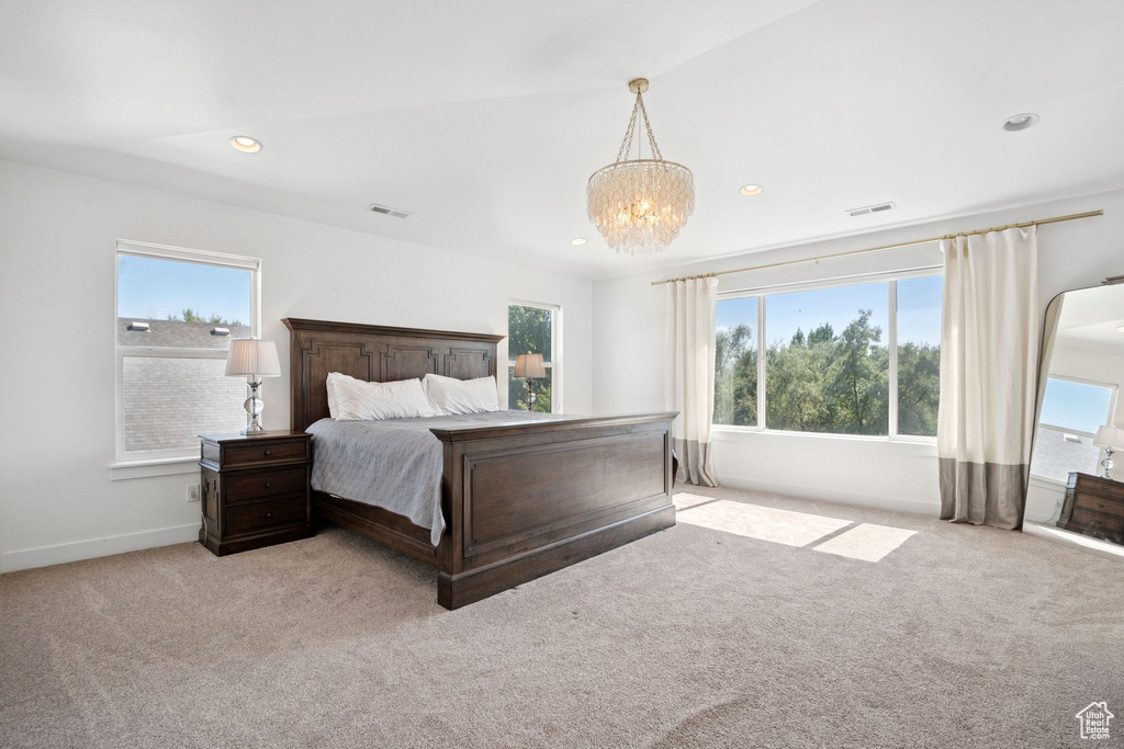 Bedroom with carpet, a chandelier, and recessed lighting