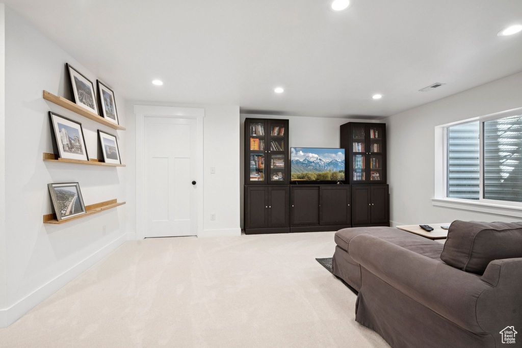 Carpeted living area with recessed lighting