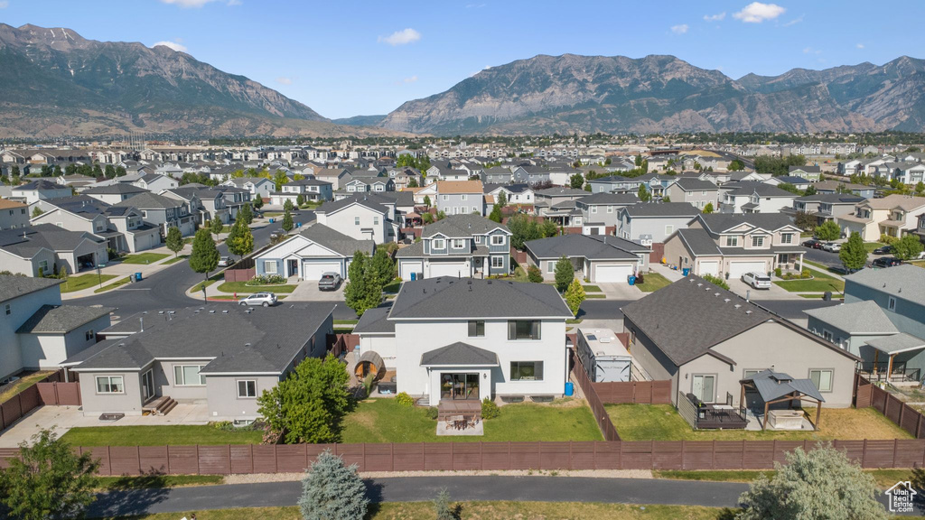 Aerial view of residential area featuring a mountainous background