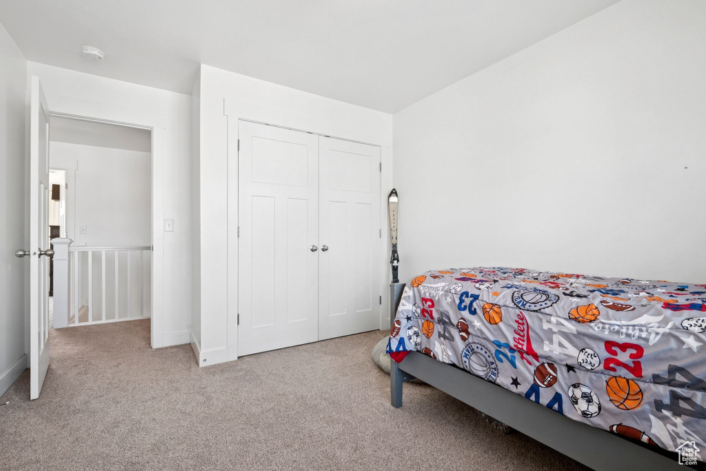Bedroom with carpet and a closet