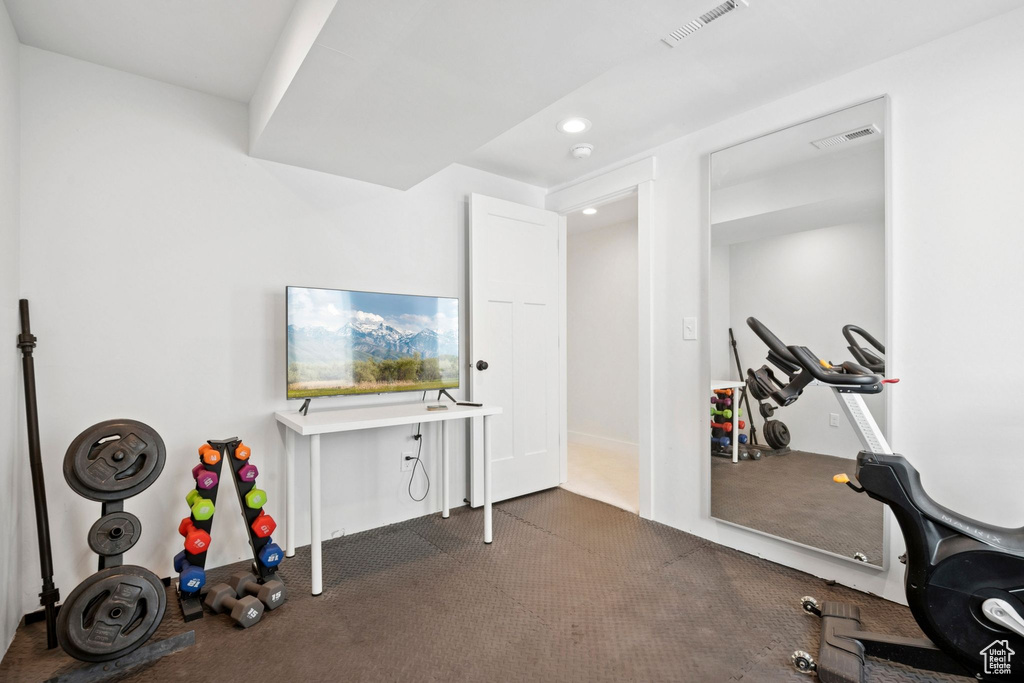 Workout room featuring recessed lighting and dark carpet