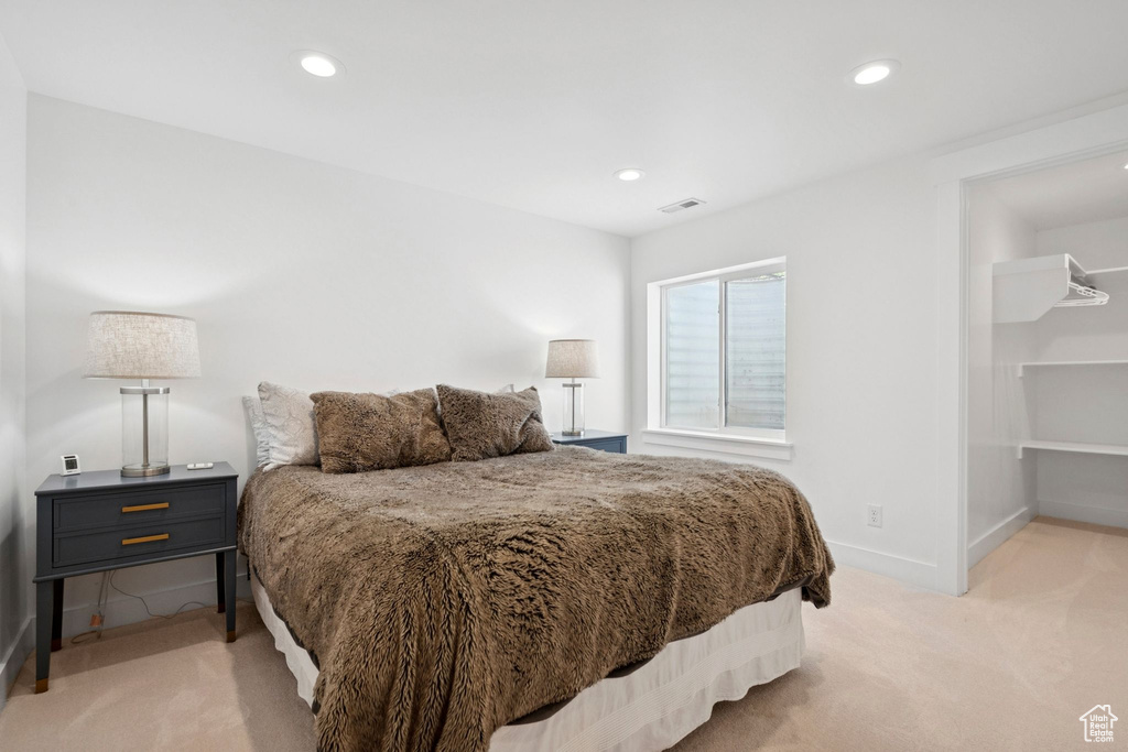 Bedroom with light carpet and recessed lighting