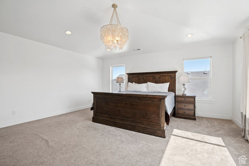 Bedroom featuring carpet flooring, multiple windows, a chandelier, and recessed lighting