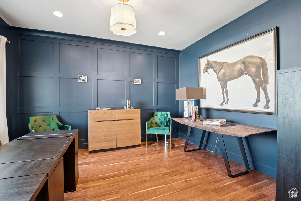 Office featuring a decorative wall, light wood-style flooring, and recessed lighting