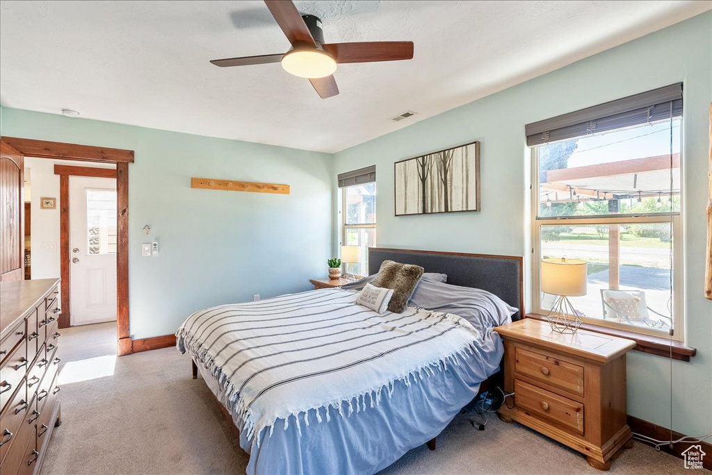 Bedroom with light carpet and ceiling fan