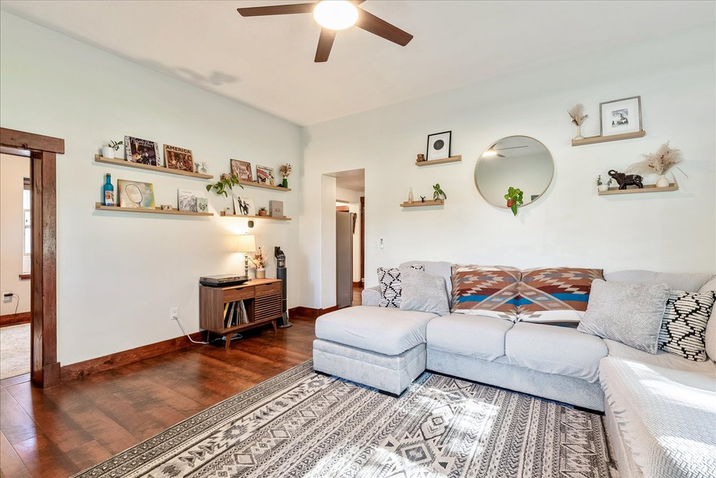 Living area with a ceiling fan and wood finished floors