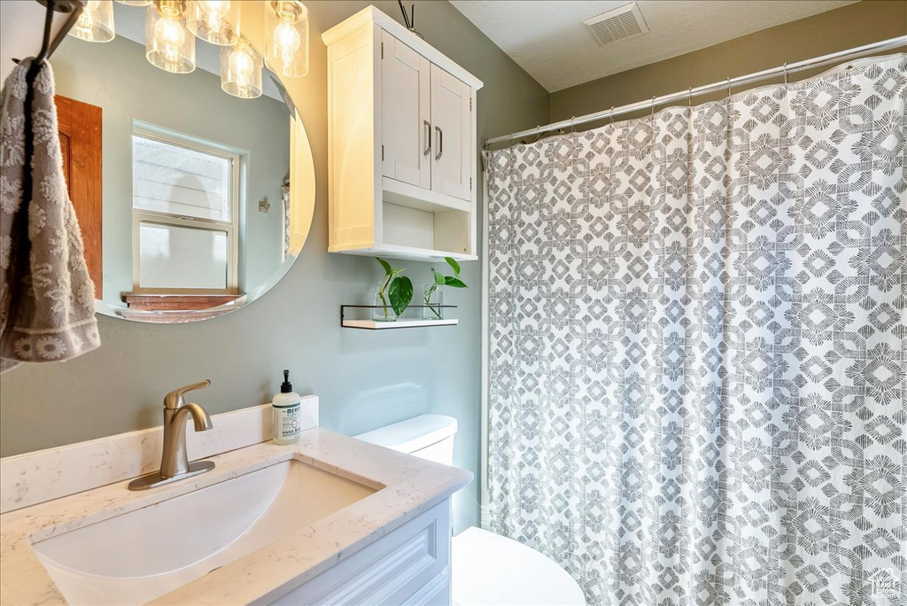 Bathroom with vanity and a shower with shower curtain