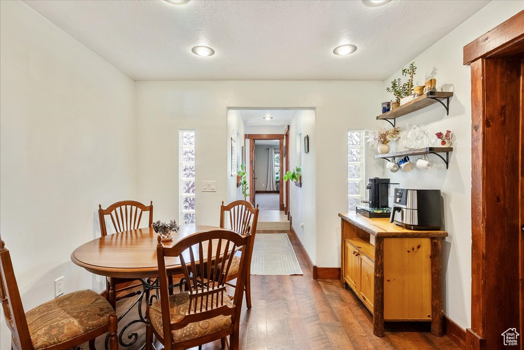 Dining space featuring healthy amount of natural light and dark wood finished floors