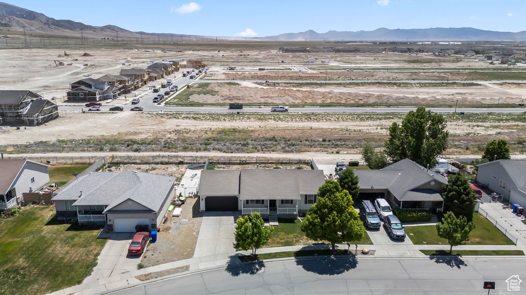 Aerial perspective of suburban area featuring a mountain backdrop