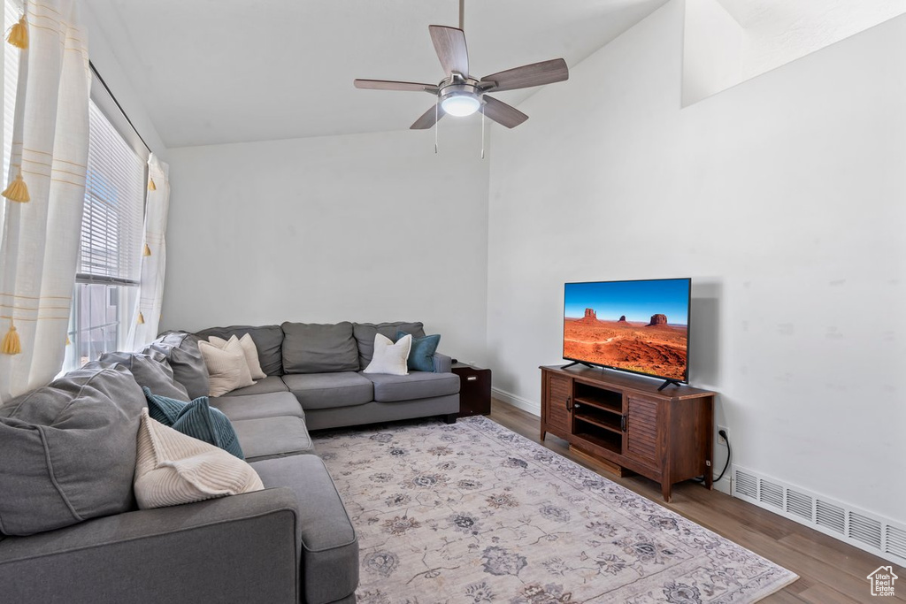 Living area featuring wood finished floors, ceiling fan, and high vaulted ceiling