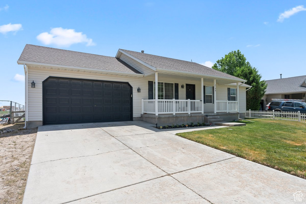 Single story home featuring a porch, an attached garage, driveway, and roof with shingles