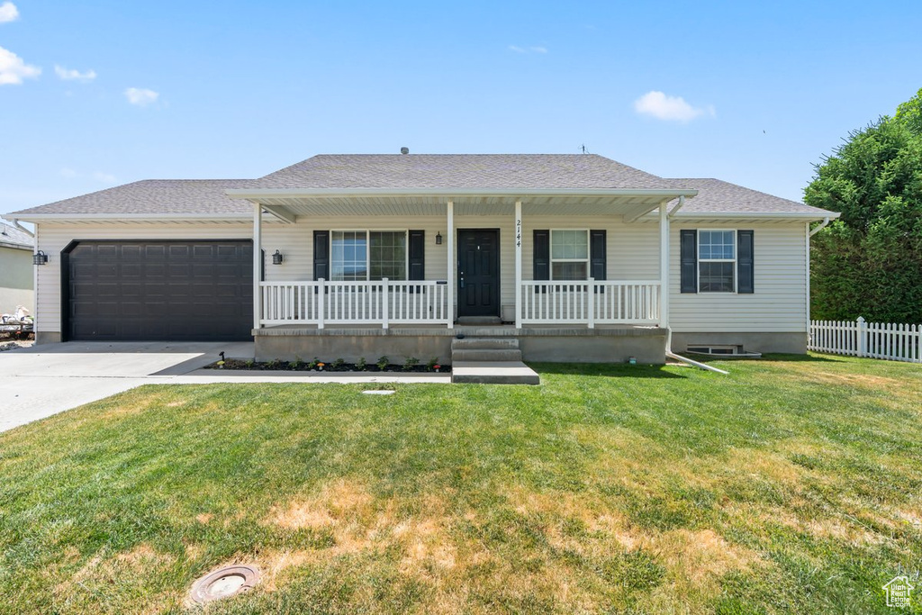 Single story home featuring a porch, a garage, and concrete driveway