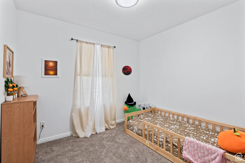 Bedroom with carpet flooring and baseboards