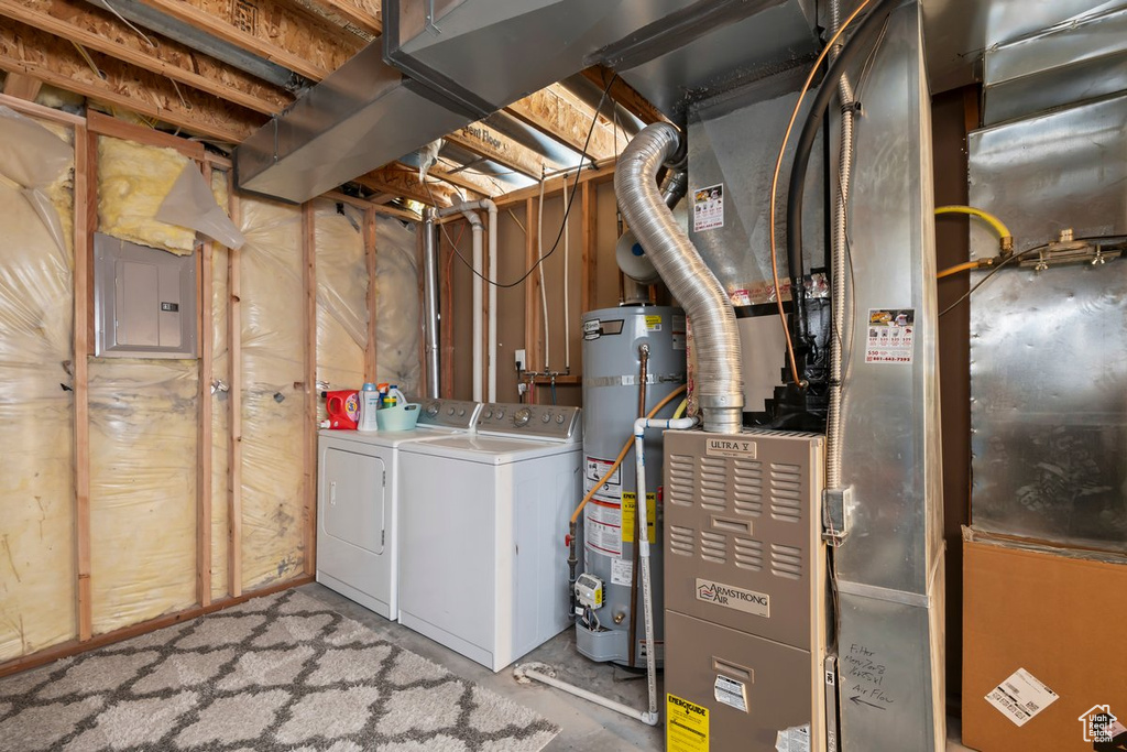 Utilities with washing machine and clothes dryer, electric panel, and gas water heater