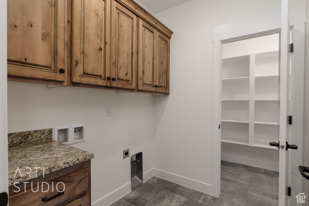 Washroom featuring cabinet space, washer hookup, and hookup for an electric dryer