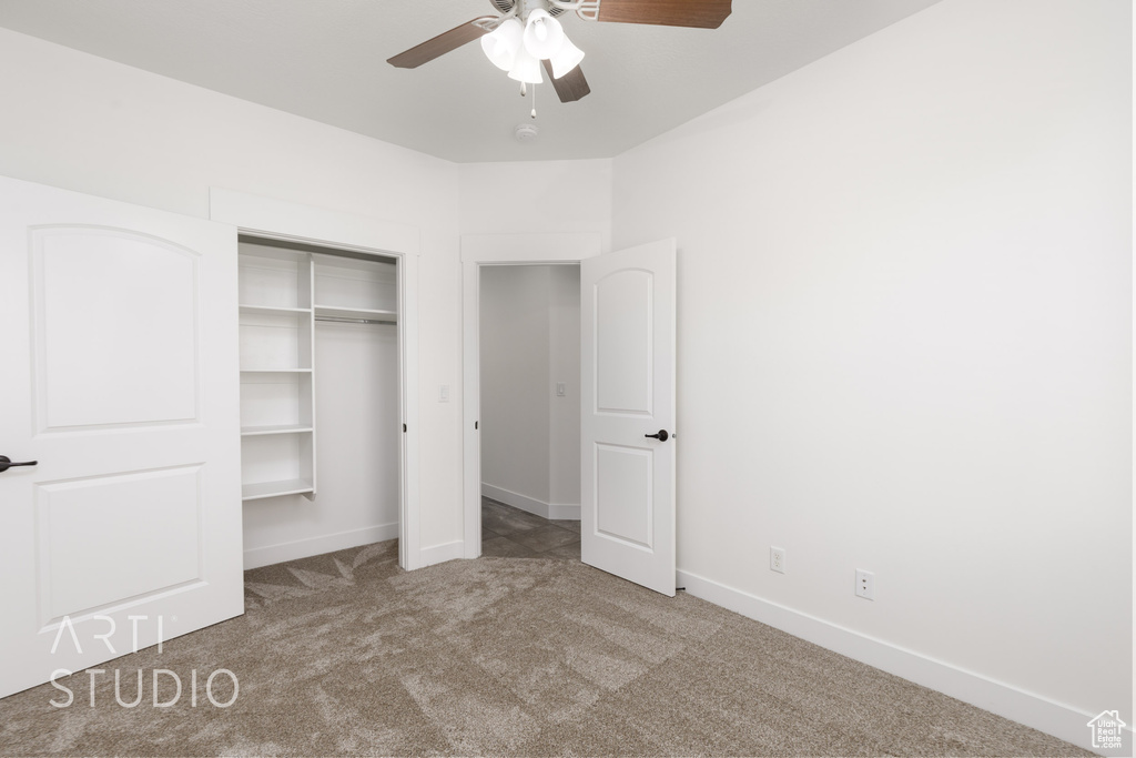 Unfurnished bedroom featuring carpet floors, a closet, and a ceiling fan