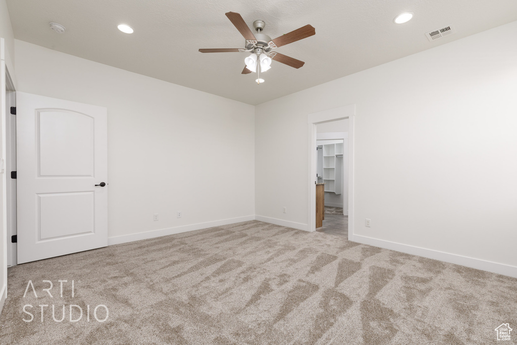 Spare room featuring carpet floors, ceiling fan, recessed lighting, and a smoke detector