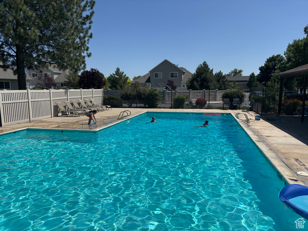 Community pool with a patio
