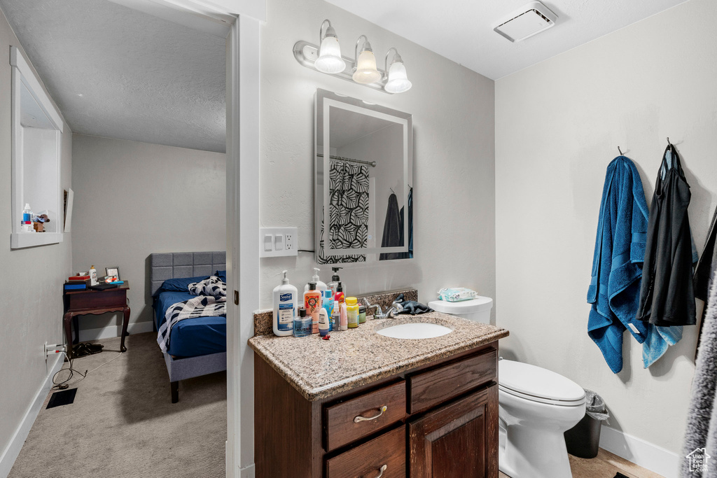 Bathroom featuring vanity and connected bathroom