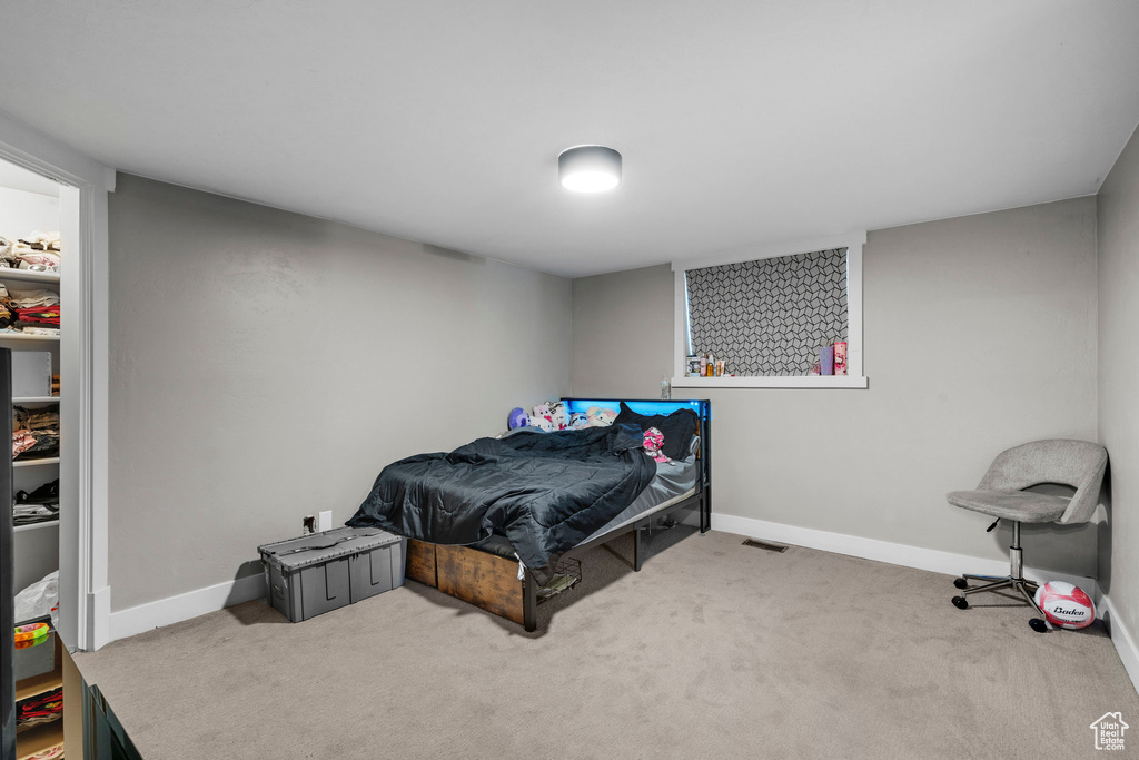 Carpeted bedroom with baseboards