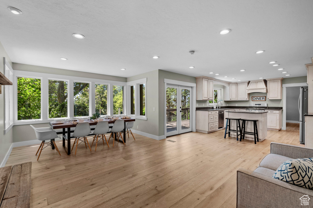 Living room with light wood-style floors and recessed lighting