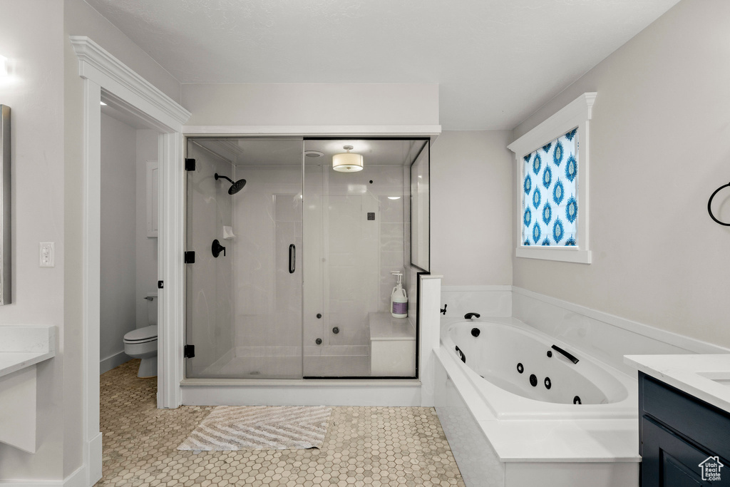 Bathroom featuring vanity, a stall shower, a whirlpool tub, and tile patterned floors