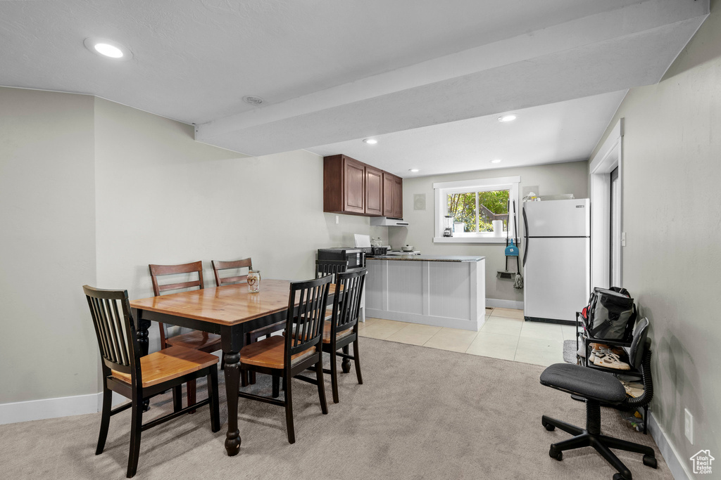 Dining area featuring recessed lighting, light colored carpet, and light tile patterned floors