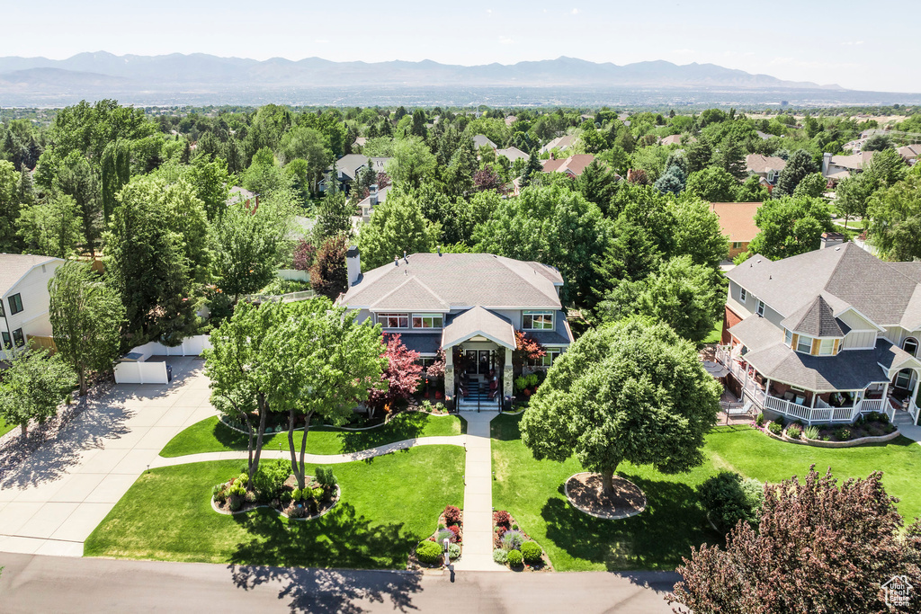 Aerial view of property and surrounding area with mountains