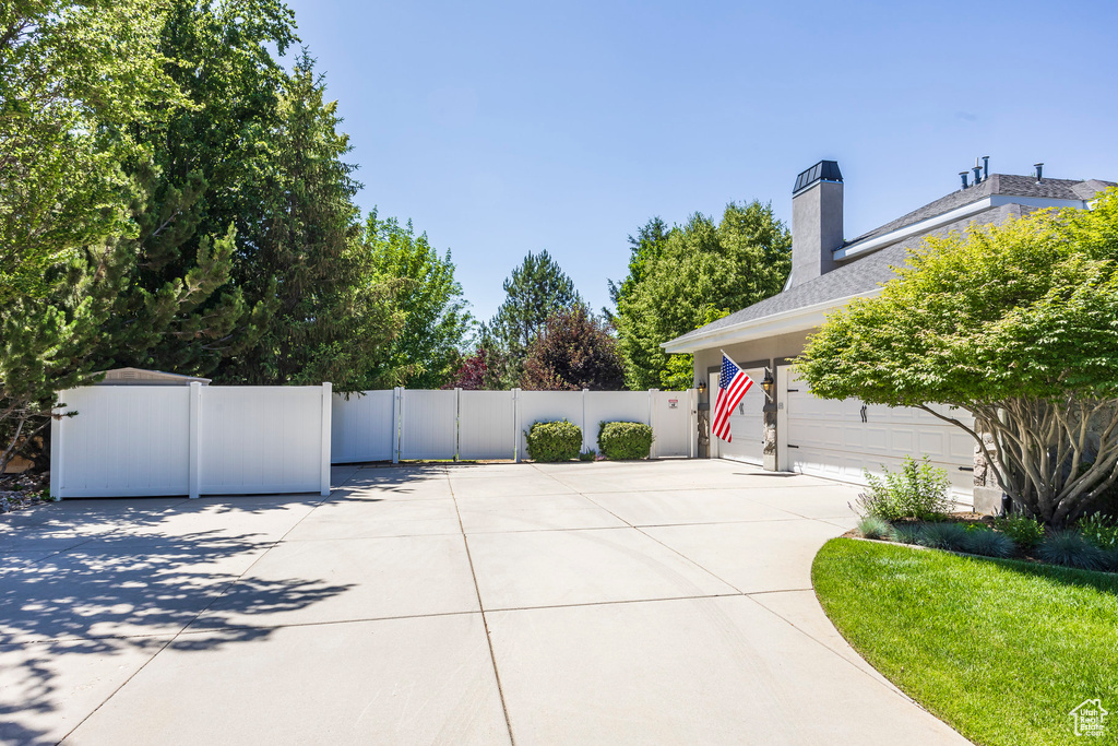 View of patio with concrete driveway