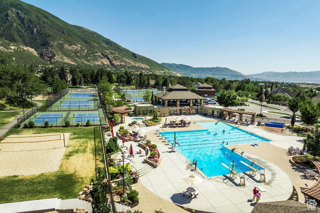 Community pool with a gazebo, a mountain view, and a patio area
